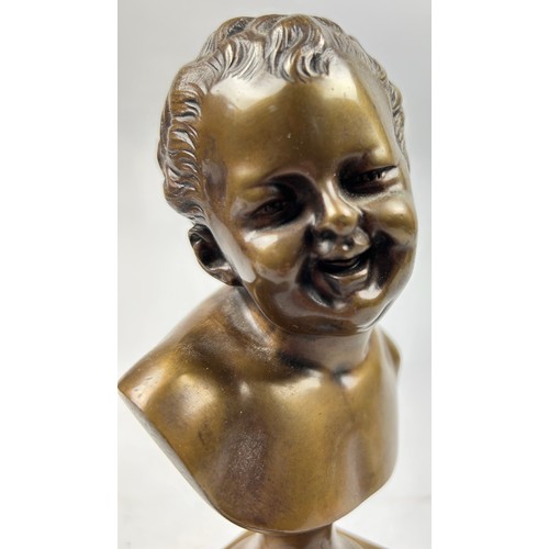 180 - AFTER JEAN-BAPTISTE CARPEAUX 1827-1875, a bronze bust of a laughing putti, mounted on a red marble s... 