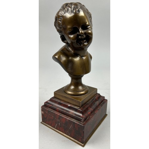 180 - AFTER JEAN-BAPTISTE CARPEAUX 1827-1875, a bronze bust of a laughing putti, mounted on a red marble s... 