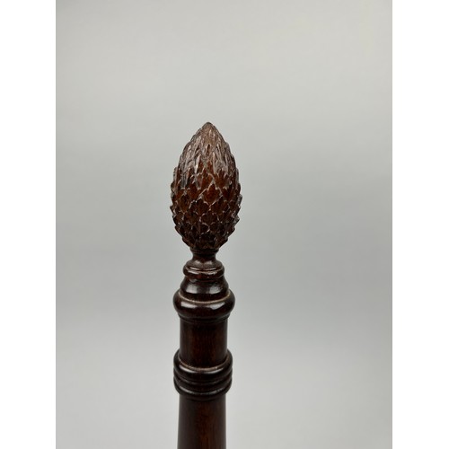 190 - A 19TH CENTURY MAHOGANY BOTTLE HOLDER, for four bottles, with carved fir cone handle.