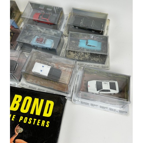 233 - A COLLECTION OF JAMES BOND DIE CAST TOY CARS BY G FABBRI WITH MAGAZINES, along with a book of poster... 