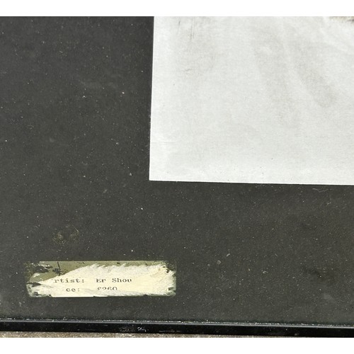 A CHINESE PASTEL AND CHARCOAL ON PAPER OF A MAN CROUCHING BESIDE A