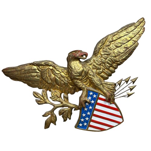 213 - A GILT PAINTED AMERICAN EAGLE WALL HANGING, above a United States Stars and Stripes with five arrows... 