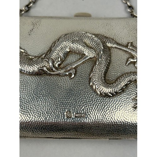 23 - AN EARLY 20TH CENTURY CHINESE SILVER CIGARETTE CASE WITH RAISED DRAGON CHASING A FLAMING PEARL, engr... 