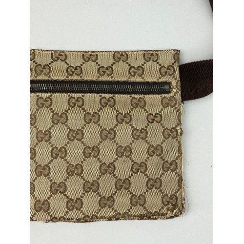 23 - A GUCCI BELT BAG WITH INTERLOCKING MONOGRAM DESIGN, 

Outer zipped compartment, and brown strap.

28... 