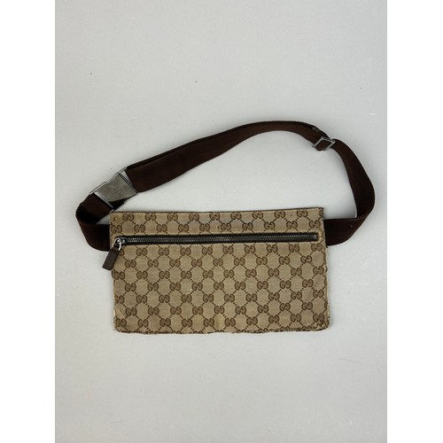 23 - A GUCCI BELT BAG WITH INTERLOCKING MONOGRAM DESIGN, 

Outer zipped compartment, and brown strap.

28... 