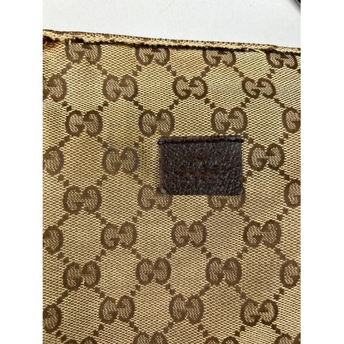 23 - A GUCCI BELT BAG WITH INTERLOCKING MONOGRAM DESIGN, 

Outer zipped compartment, and brown strap.

28... 