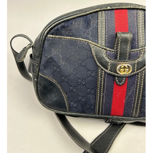 24 - A GUCCI SIDE BAG IN NAVY BLUE WITH INTERLOCKING MONOGRAM EMBLEM AND LEATHER STRAP

32cm x 23cm

Good... 