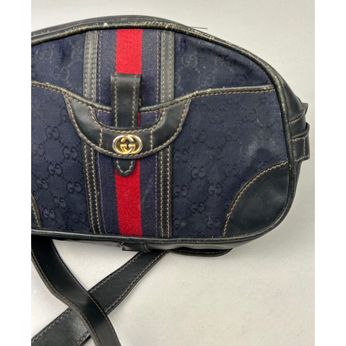 24 - A GUCCI SIDE BAG IN NAVY BLUE WITH INTERLOCKING MONOGRAM EMBLEM AND LEATHER STRAP

32cm x 23cm

Good... 