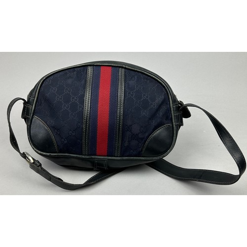 24 - A GUCCI SIDE BAG IN NAVY BLUE WITH INTERLOCKING MONOGRAM EMBLEM AND LEATHER STRAP

32cm x 23cm

Good... 