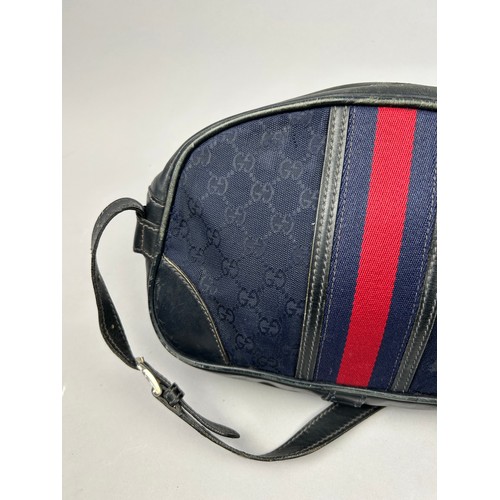 24 - A GUCCI SIDE BAG IN NAVY BLUE WITH INTERLOCKING MONOGRAM EMBLEM AND LEATHER STRAP

32cm x 23cm

Good... 