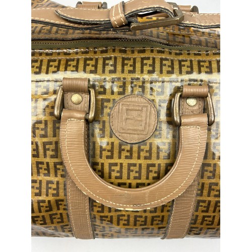 50 - A VINTAGE FENDI 'TOFFEE WRAPPER' DUFFLE BAG, with monogram 'FF' design throughout, two brown leather... 