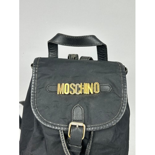 43 - A VINTAGE MOSCHINO BACKPACK RUCKSACK, black with gold hardware spelling out 'Moschino' with various ... 