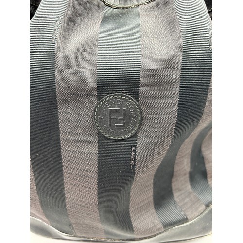 10 - A VINTAGE FENDI BUCKET BAG, navy blue and grey stripes with central interlocking 'FF' emblem. 

Draw... 