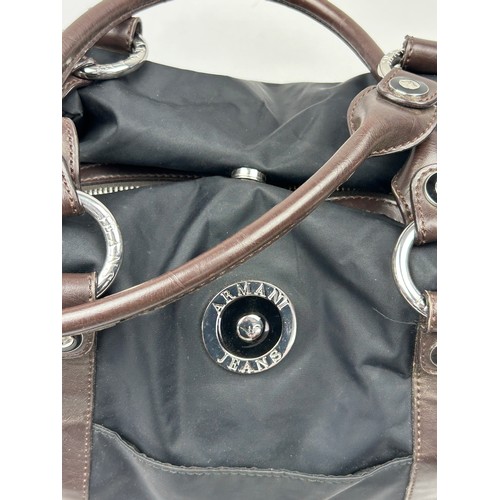 34 - AN ARMANI JEANS BLACK NYLON HANDBAG, with brown leather straps and chrome emblem

38cm x 35cm 

Very... 