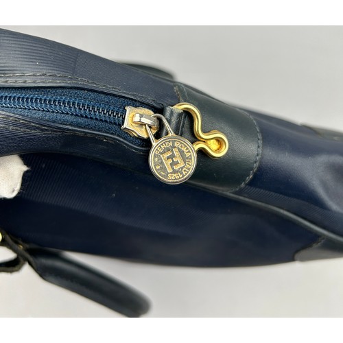 14 - A VINTAGE FENDI HANDBAG, blue strips with gold coloured metal hardware and central zipped compartmen... 