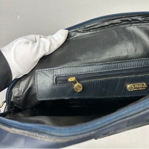 14 - A VINTAGE FENDI HANDBAG, blue strips with gold coloured metal hardware and central zipped compartmen... 