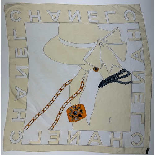 119 - A LARGE VINTAGE CHANEL SILK SCARF DEPICTING A LADY WEARING A HAT AND VARIOUS GOLD JEWELLERY,

85cm x... 