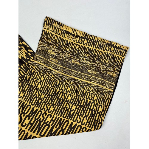 120 - A VINTAGE MOSCHINO SILK SCARF IN BLACK AND YELLOW WITH MONOGRAM PRINT THROUGHOUT,

150cm in length 
... 