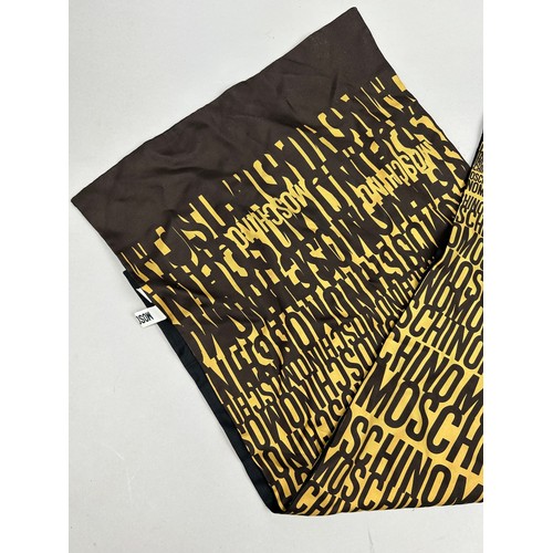 120 - A VINTAGE MOSCHINO SILK SCARF IN BLACK AND YELLOW WITH MONOGRAM PRINT THROUGHOUT,

150cm in length 
... 