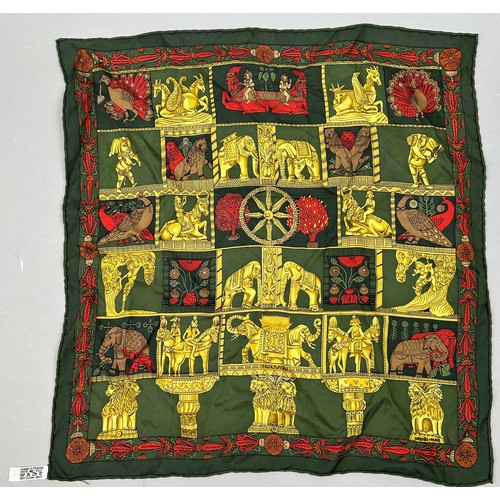 125 - A VINTAGE HERMES SILK SCARF IN THE CLASSICAL STYLE, green, gold and red decorated with lions, peacoc... 