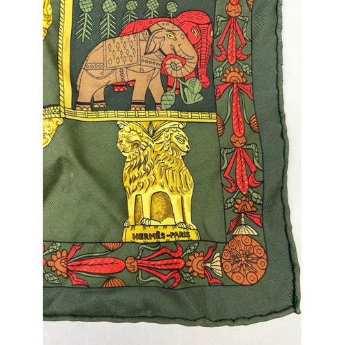 125 - A VINTAGE HERMES SILK SCARF IN THE CLASSICAL STYLE, green, gold and red decorated with lions, peacoc... 