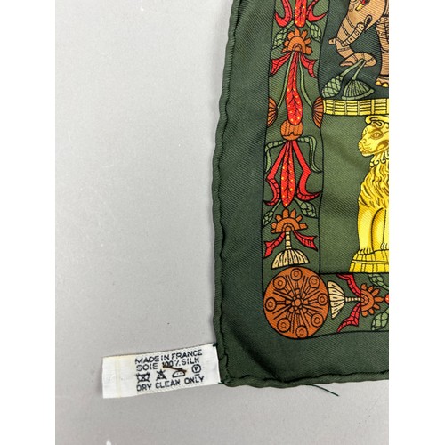 125 - A VINTAGE HERMES SILK SCARF IN THE CLASSICAL STYLE, green, gold and red decorated with lions, peacoc... 