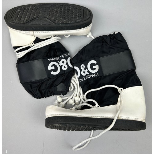 106 - A PAIR OF DOLCE AND GABBANA SKI BOOTS. black and white with logo's