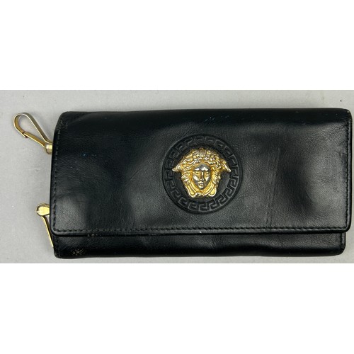 59 - A VERSACE BLACK LEATHER WALLET, with gold coloured hardware