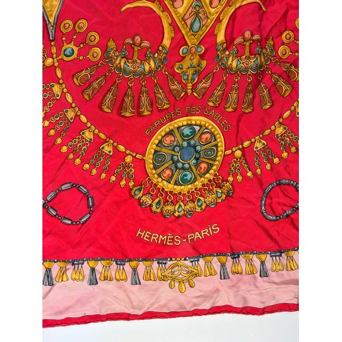 132 - A LARGE VINTAGE HERMES SILK SCARF, red, gold and pink depicting various articles of archaic jeweller... 