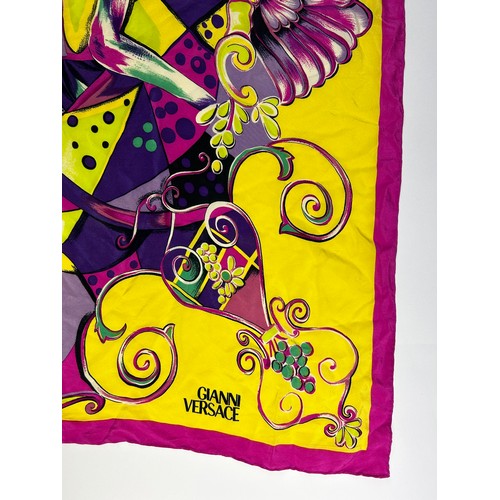 133 - A LARGE VINTAGE GIANNI VERSACE SILK SCARF, pink, green and purple with Medusa head centre left

80cm... 