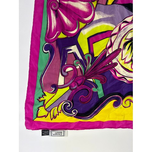 133 - A LARGE VINTAGE GIANNI VERSACE SILK SCARF, pink, green and purple with Medusa head centre left

80cm... 