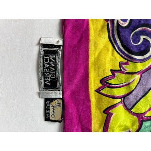 133 - A LARGE VINTAGE GIANNI VERSACE SILK SCARF, pink, green and purple with Medusa head centre left

80cm... 