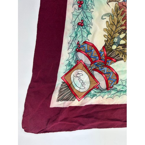 134 - A VINTAGE GUCCI SILK SCARF, of foliate design depicting a gentleman walking in a winter landscape

7... 