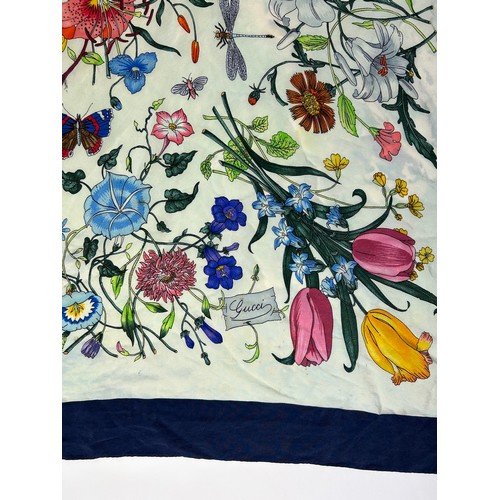 135 - A LARGE VINTAGE GUCCI SILK SCARF, of colourful foliate design with blue border

77cm x 77cm 

Very g... 