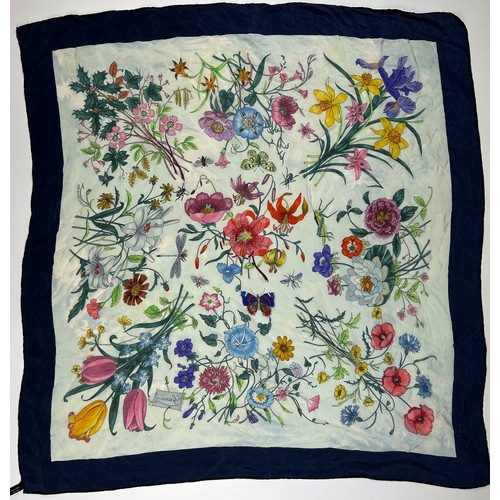 135 - A LARGE VINTAGE GUCCI SILK SCARF, of colourful foliate design with blue border

77cm x 77cm 

Very g... 