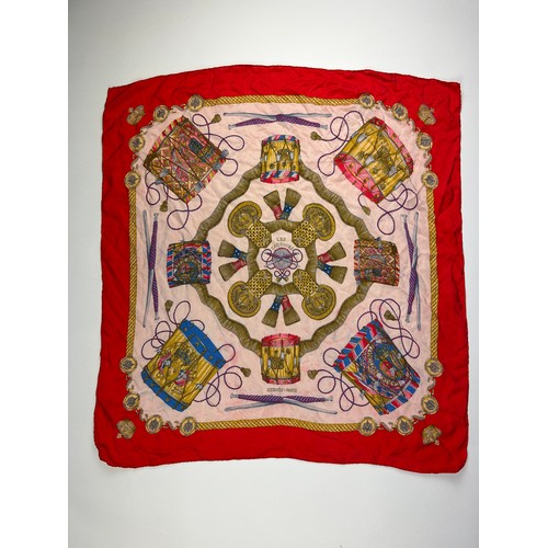 136 - A LARGE VINTAGE HERMES SILK SCARF, red, gold and pink with instrument design throughout

75cm x 75cm... 