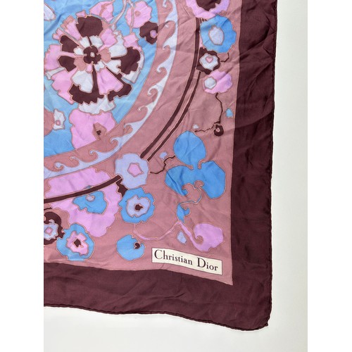 137 - A VINTAGE CHRISTIAN DIOR SILK SCARF, of blossoming foliate design blue, pink and purple with 'Christ... 