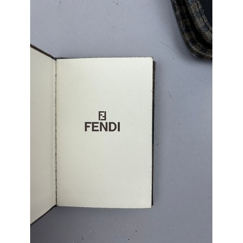 57 - A SELECTION OF FIVE VINTAGE FENDI WALLETS AND ACCESSORIES, to include two red, one brown vanity set,... 