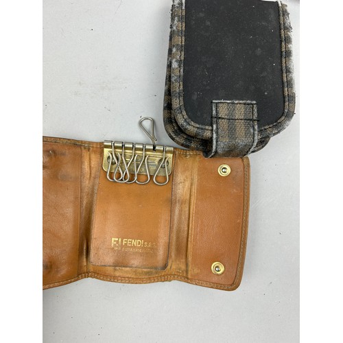 57 - A SELECTION OF FIVE VINTAGE FENDI WALLETS AND ACCESSORIES, to include two red, one brown vanity set,... 