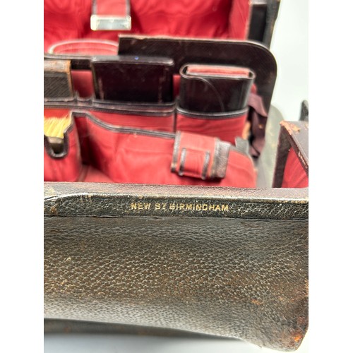 154 - A GENTLEMAN'S VANITY CASE, with silver topped bottles