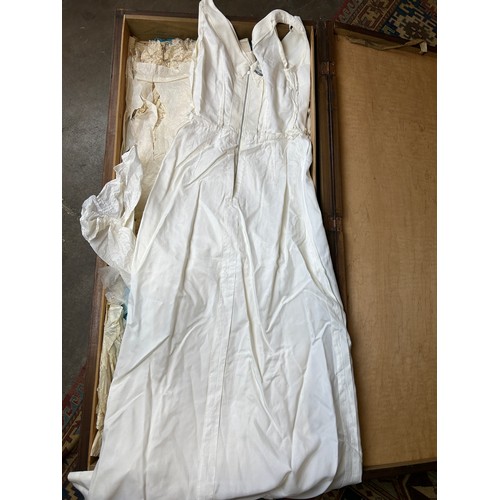 153 - A LARGE TRAVEL WARDROBE ON CASTORS CONTAINING DRESSES AND OUTFITS FROM THE 1940's-1960's including l... 