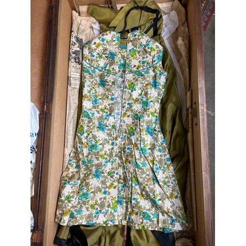 153 - A LARGE TRAVEL WARDROBE ON CASTORS CONTAINING DRESSES AND OUTFITS FROM THE 1940's-1960's including l... 