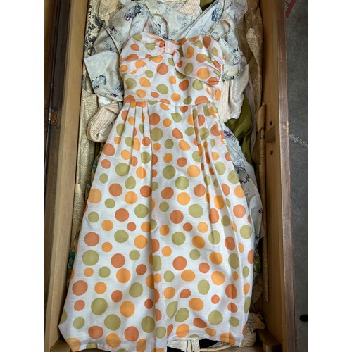 153 - A LARGE TRAVEL WARDROBE ON CASTORS CONTAINING DRESSES AND OUTFITS FROM THE 1940's-1960's including l... 