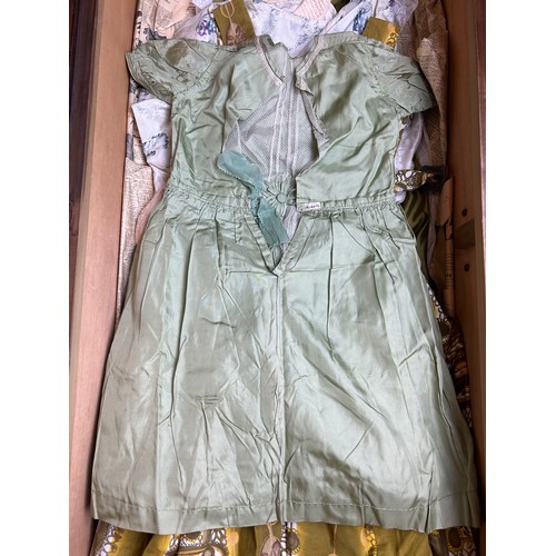 153 - A LARGE TRAVEL WARDROBE ON CASTORS CONTAINING DRESSES AND OUTFITS FROM THE 1940's-1960's including l... 