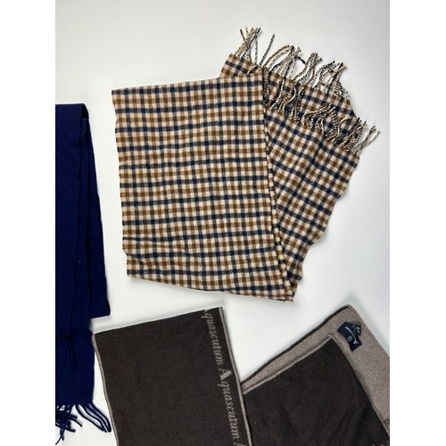 112 - A BURBERRY SCARF ALONG WITH TWO AQUASCUTUM SCARVES, 

The Burberry in navy blue with subtle crested ... 