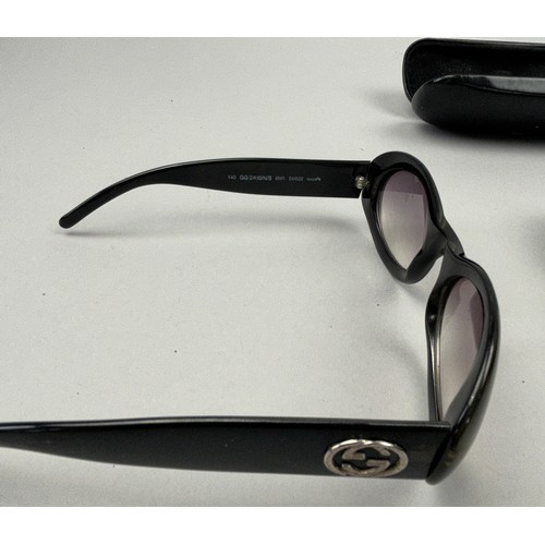 62 - THREE PAIRS OF GUCCI SUNGLASSES, one in a case. 

Interlocking GG hardware on two, and Gucci emblem ... 