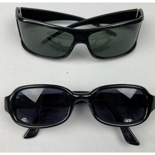 63 - TWO PAIRS OF BLACK GUCCI SUNGLASSES, both with Gucci emblems on each side