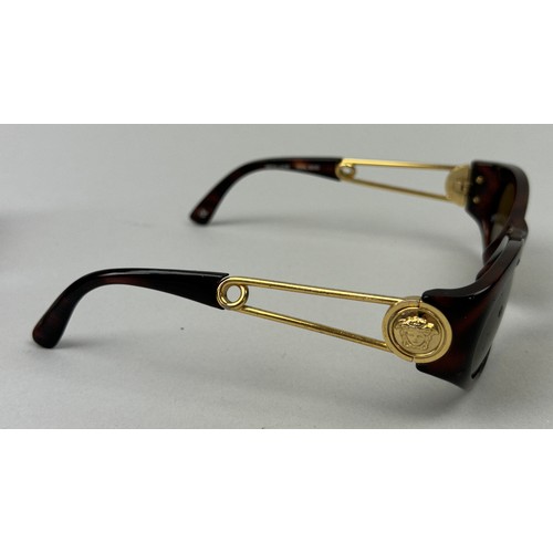 69 - THREE GIANNI VERSACE TORTOISESHELL DESIGN SUNGLASSES, all with gold 'Medusa head' detailing.