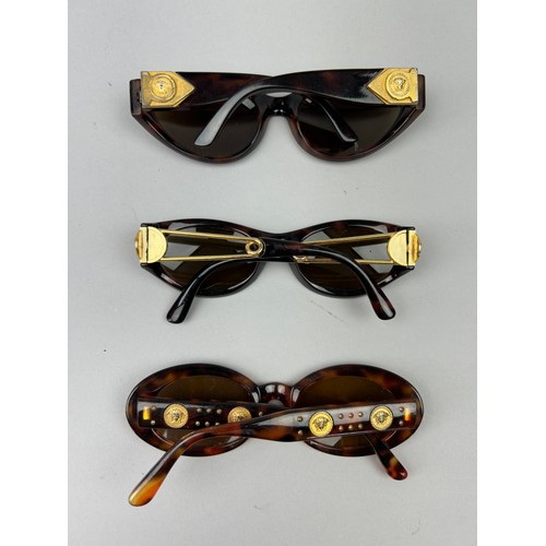 69 - THREE GIANNI VERSACE TORTOISESHELL DESIGN SUNGLASSES, all with gold 'Medusa head' detailing.