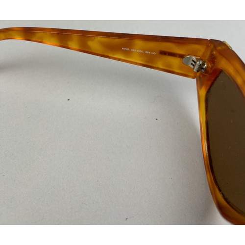 70 - A SET OF THREE VERSUS VERSACE SUNGLASSES, two orange and another with black frames and grey rims.

S... 